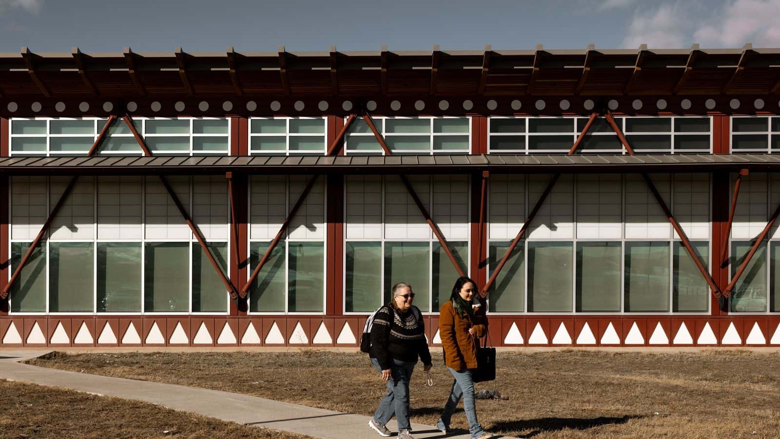 A student, left, and college staff member walk through the Blackfeet Community College campus in Browning, Montana. The Trump administration has proposed deep cuts to tribal colleges across the country. Credit:Rebecca Stumpf for ProPublica