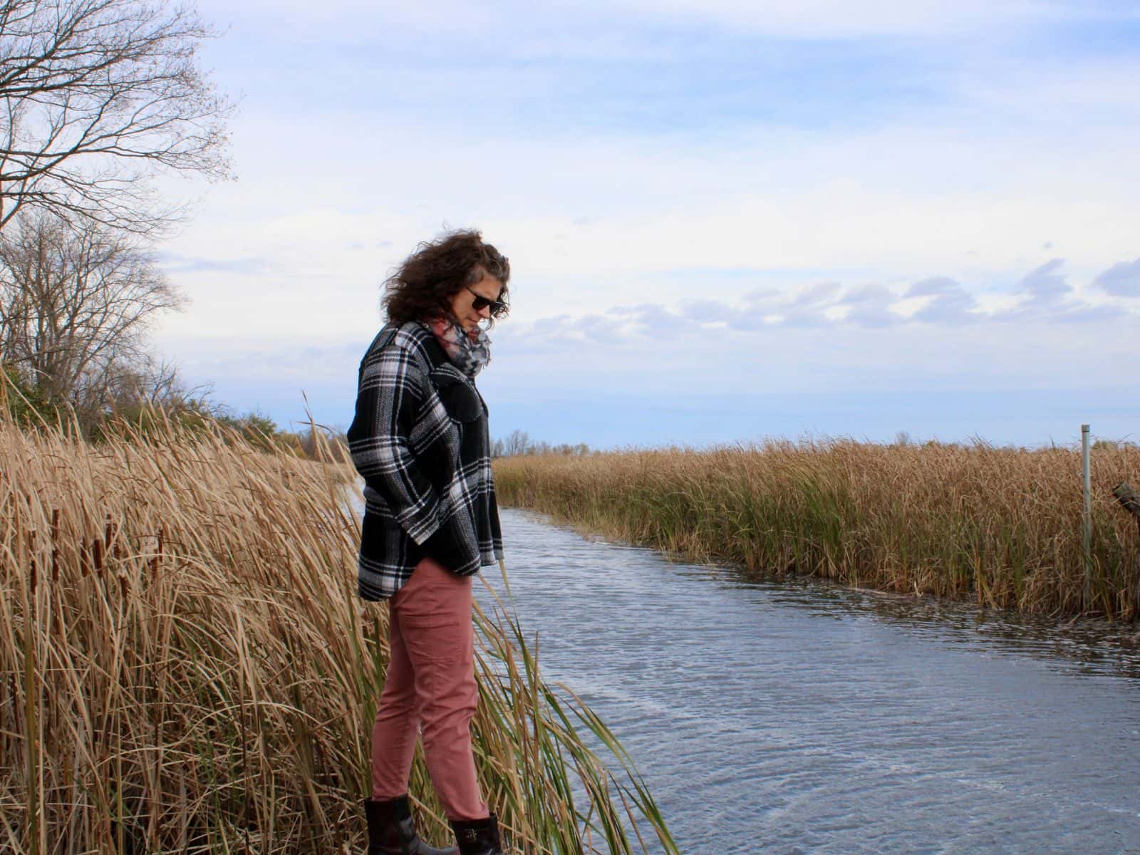Brandy Toft, environmental director for the Leech Lake Division of Resource Management, looks down at Pike Bay Channel, where the St. Regis Paper Co. Superfund Site’s water treatment plant pumps its effluent, Cass Lake, Minnesota.