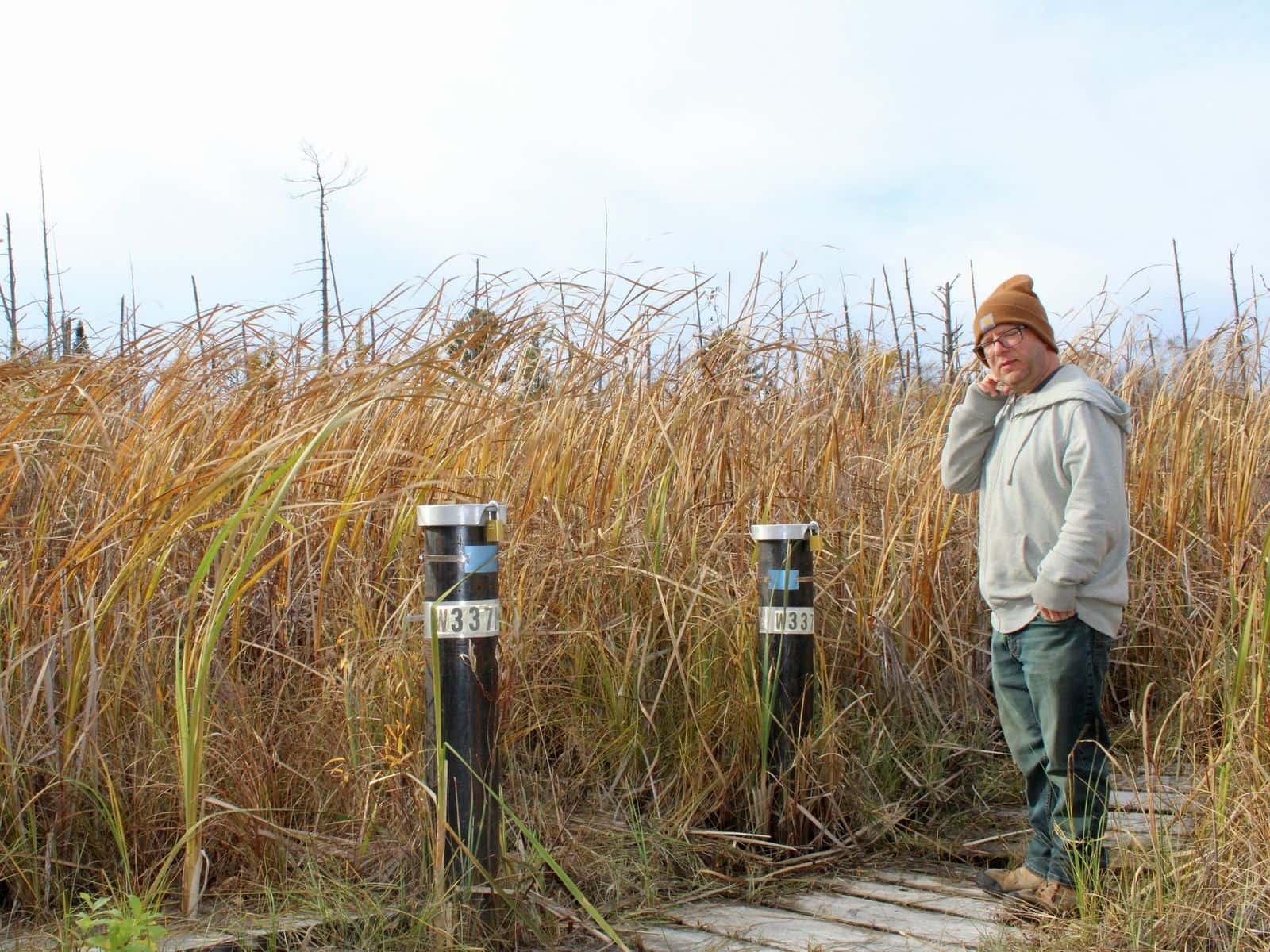Eric Krumm, superfund coordinator for the Leech Lake Division of Resource Management, stands next to monitoring wells at Fox Creek Valley, Cass Lake, Minnesota.
