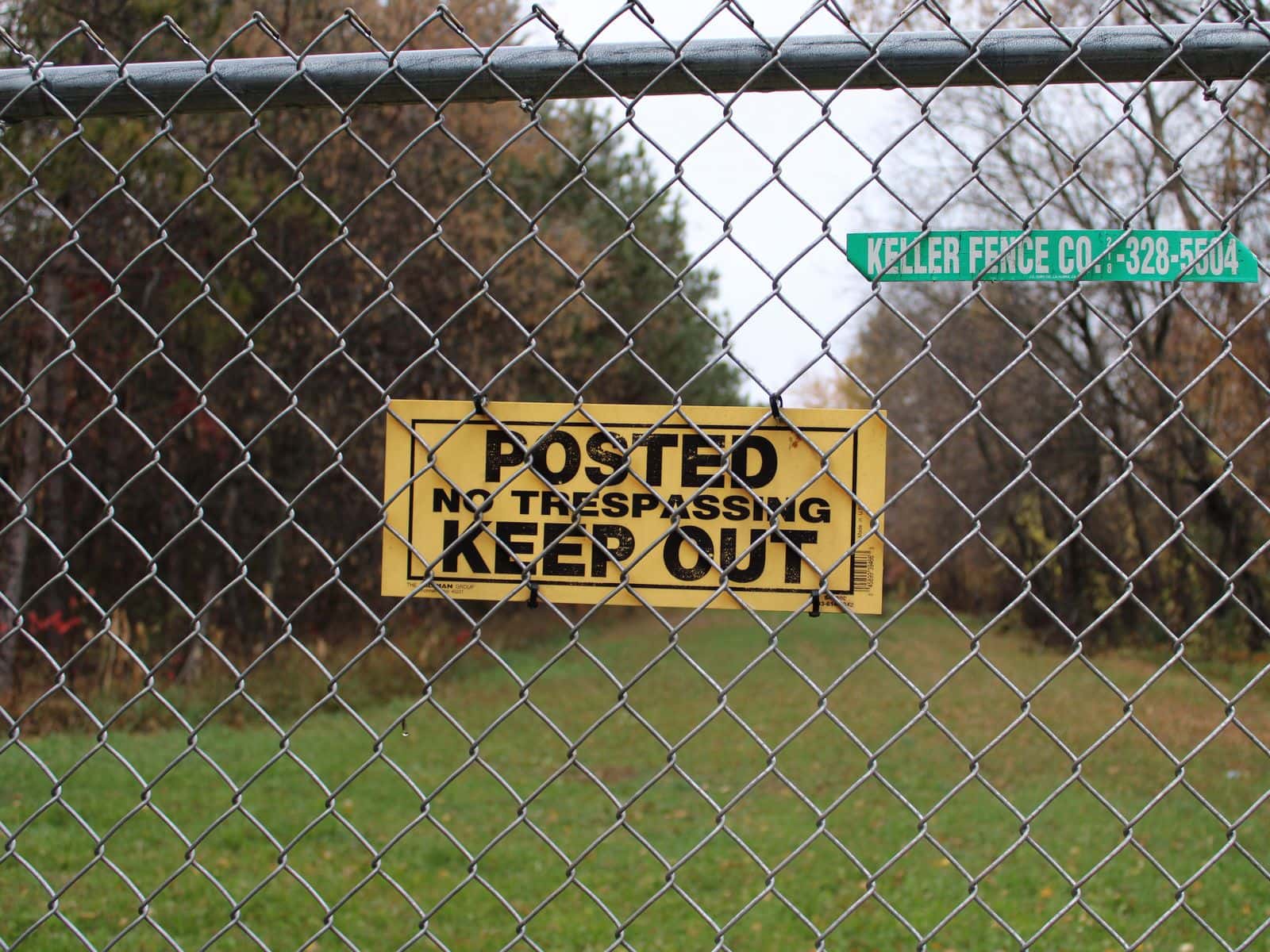 A “KEEP OUT” sign posted on a fence warns residents and visitors on the St. Regis Paper Co. Superfund Site, Cass Lake, Minnesota.