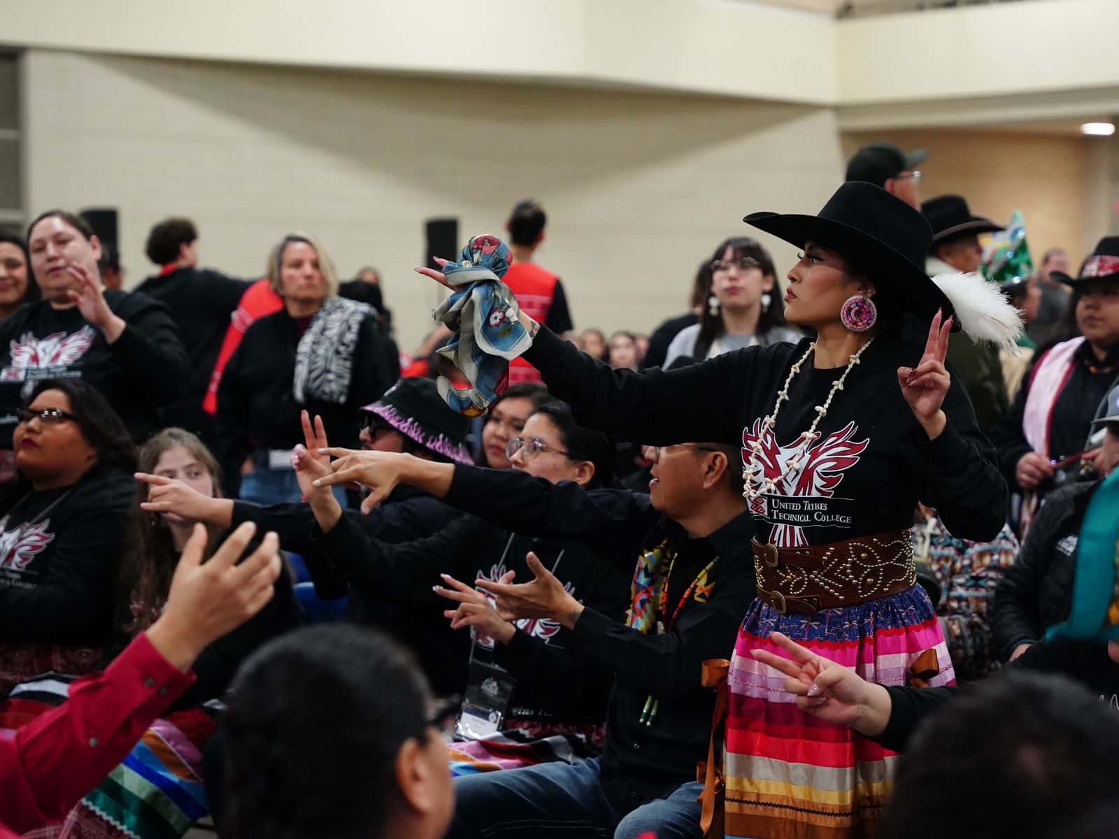 Zariah Whiteplume, standing, serves as the United Tribes Technical College team captain for the hand games tournament at the 2026 AIHEC conference, Bismarck, North Dakota.