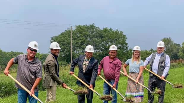 Iowa Tribe of Kansas and Nebraska leaders and others break ground on July 17, 2023, at the site of a future free trade zone that the tribe is building near its northeastern Kansas reservation. From left to right: Brandon Roberts, tribal member and deputy general manager of Grey Snow Construction Services; Benson Saulo, Australian consul-general and trade and investment commissioner; tribal Chairman Timothy Rhodd; tribal Secretary Tony Fee; tribal member Cheyenne Colborn; and tribal Vice-Chairman Lance Foster. (Courtesy of Iowa Tribe)