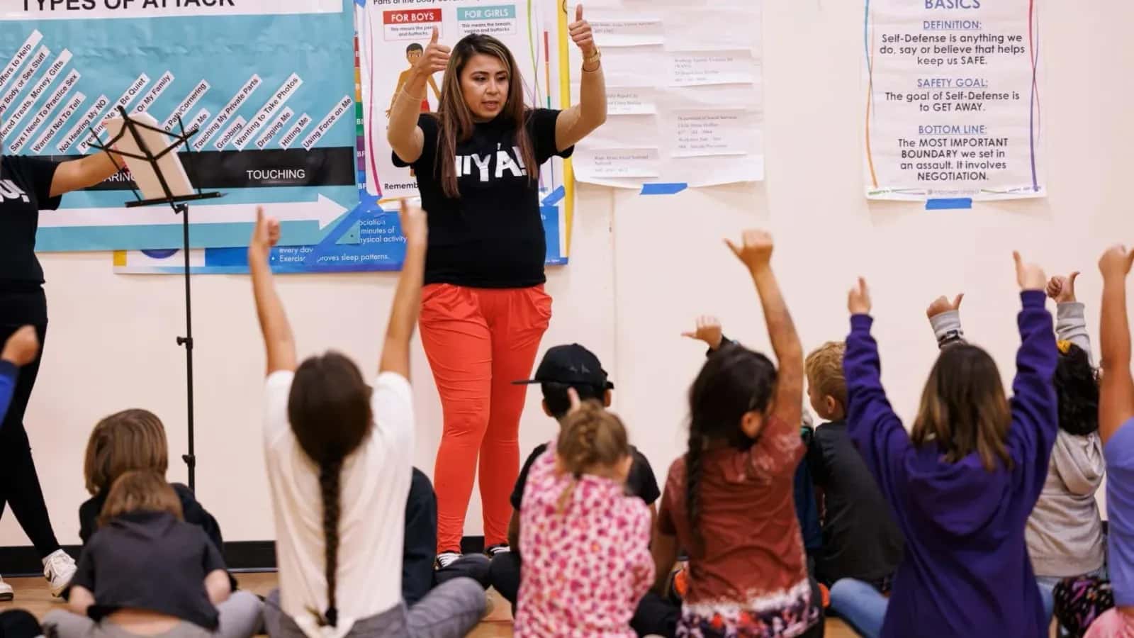 Sharay Brewer asks the children in the Martin Grade School to give her thumbs up if they understand the lesson. Hiyá is Lakota for no. The Peaceful Means program championed by Nebraska researcher Katie Edwards wants to stop sexual violence on the Pine Ridge Reservation by educating school-age children. (Photo by University of Nebraska Communications)