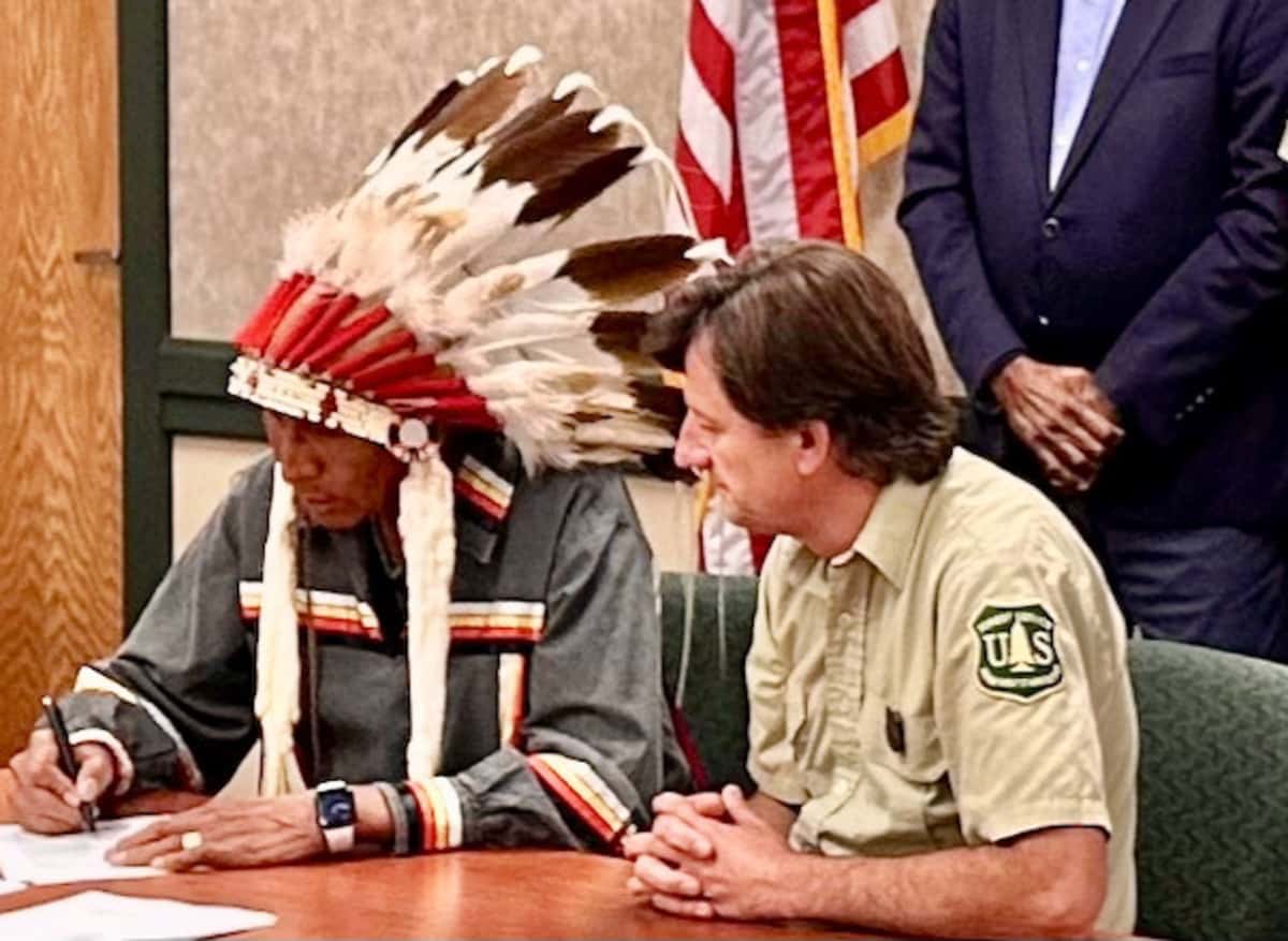 In Rapid City, South Dakota, on Aug. 22, Arvol Looking Horse signed the Great Sioux Nation and U.S. Forest Service MOU on Black Hills co-stewardship. Accompanying him was Black Hills National Forest Supervisor Shawn Cochran. (Photo credit/  Mark Van Norman)