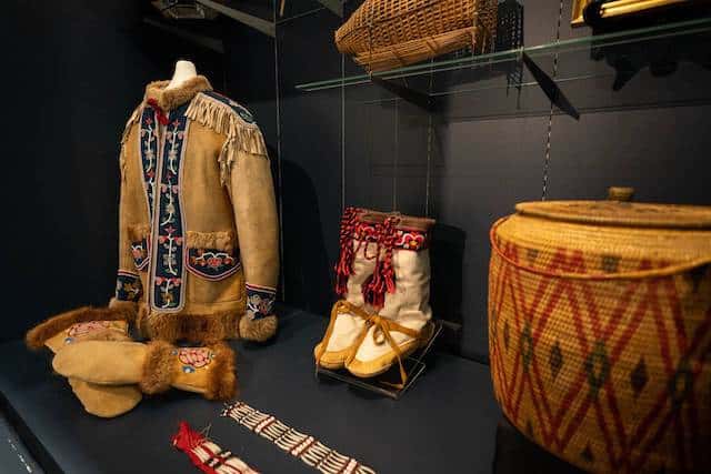 Athabascan objects, including a chief's coat from the Tanacross area, are displayed at the Alaska Native Heritage Center on Friday, April 22, 2022. The objects are some of 1,744 items that were donated to the center by Wells Fargo. (Loren Holmes / ADN)

Anchorage Daily News