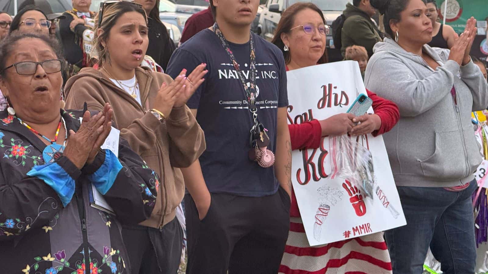 Alva Cottonwood-Gabe, leader of the Standing Rock Missing and Murdered Indigenous Relatives, joins family members of Renzo Bullhead during the Red Dress Special. Bullhead went missing in March. He was last seen crossing the train bridge into Bismarck from Mandan. His family is still searching for him. (Photo credit: Erin Hoover Barnett) 