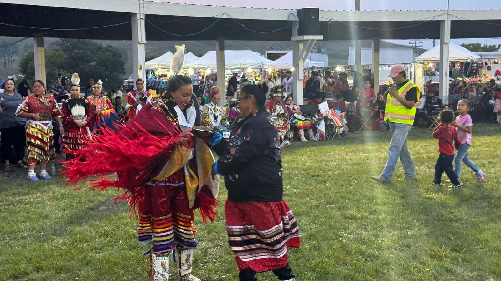 Alva Cottonwood-Gabe presents $400 and a star quilt to first-place winner Tanski Clairmont of Spirit Lake. Donations from MMIR families covered the monetary awards, which also included $300 for second place, $200 for third place, $100 for fourth place, and six consolation prizes of $50 each. The Standing Rock MMIR group raised funds to have the star quilts made. (Photo credit: Erin Hoover Barnett) 