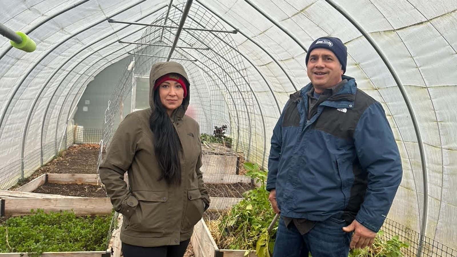 Beth Willup and Joe Quintasket stand in the Swinomish community garden greenhouse, January 2025.