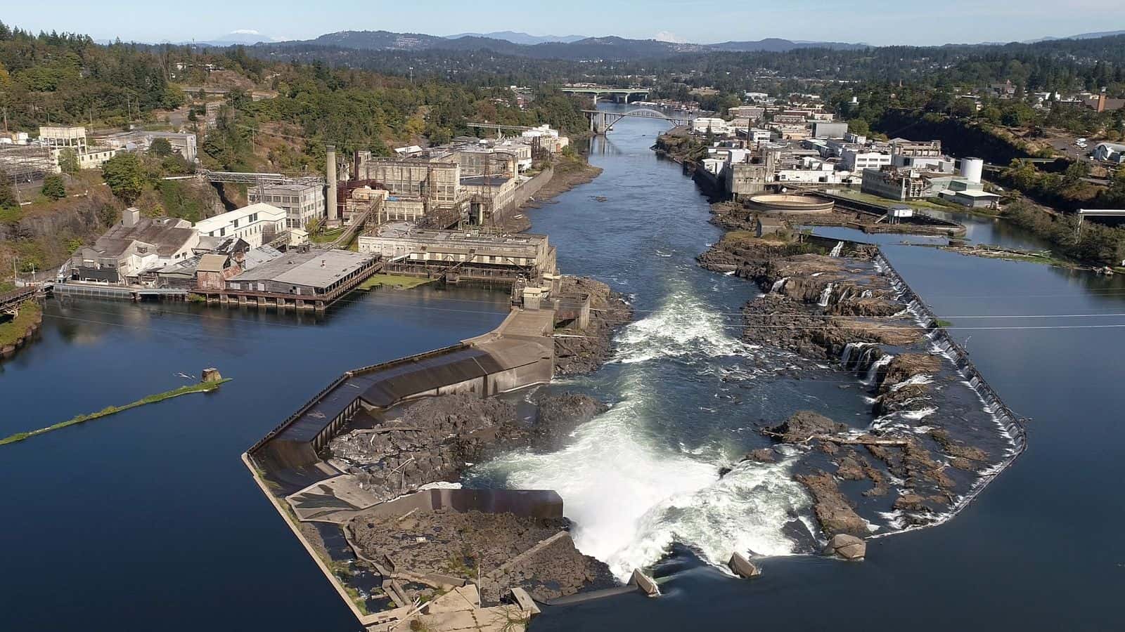 An aerial view of Willamette Falls and the former Blue Heron paper mill.  The Confederated Tribes of Grand Ronde marked the beginning of on-site work at the mill on Tues., Sept. 21, 2021.  Demolition of one of the mill's buildings was started. The tribes acquired the property in 2019 and plans on restoring the site ecologically while also creating mixed-use development and public gathering spaces.