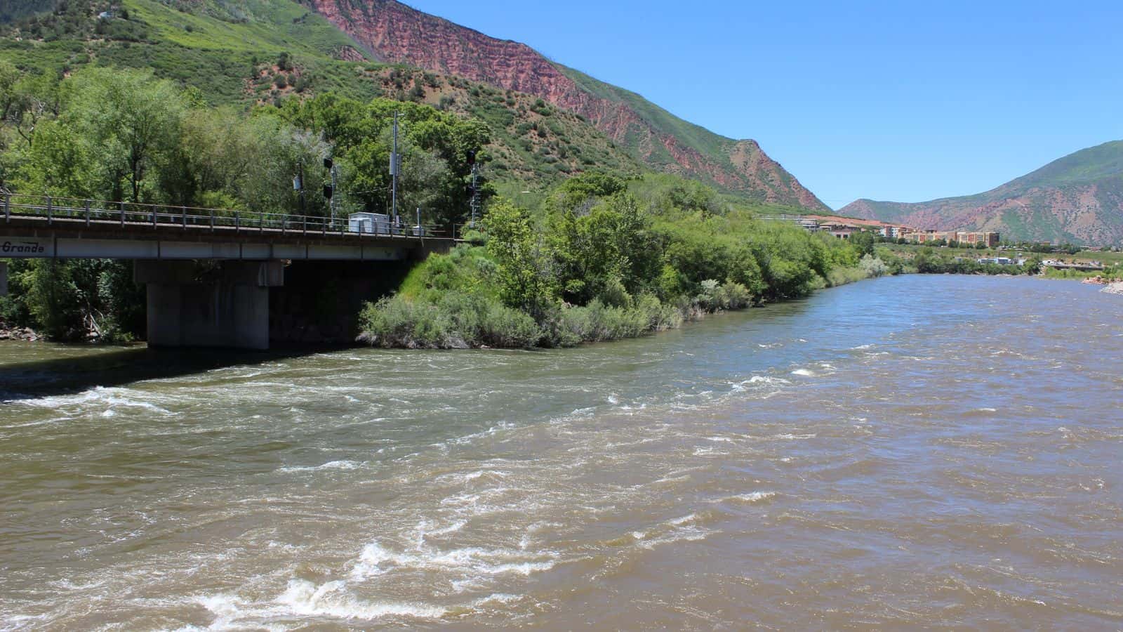 The confluence of the Roaring Fork and Colorado rivers in Glenwood Springs shows the differences between the two rivers in color and chemistry. But both have faced lower flows and warmer temperatures in recent years, impacted by human caused climate change.