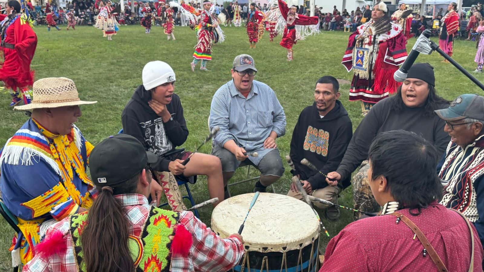 Drummers bring their dedication, passion, and talent to the Red Dress Special. “For us to be chosen to sing for something so meaningful, it just meant so much more,” said Cameron Red Bear, pictured wearing the plaid shirt. “I felt proud to sing for it.” (Photo credit: Erin Hoover Barnett) 