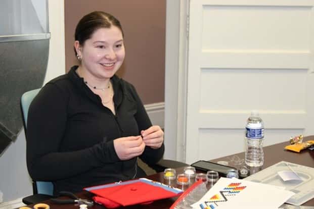 Emma Vallie, 18, beads her graduation cap on April 1 as a student engaged with the United Tribes Technical College’s Monarch Project. Houle is the 2023 senior class valedictorian at Century High School in Bismarck, N.D. Photo by: Jodi Rave Spotted Bear