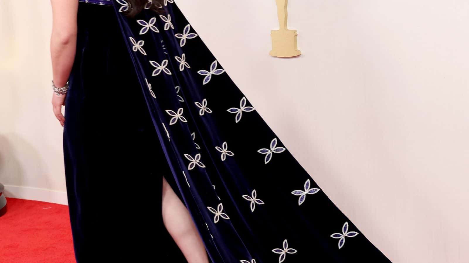 Midnight-blue velvet gown with porcupine-quill neckline and cape with quilled floral details, 2024 Velvet cloth, dyed and natural porcupine quills, sterling silver and silverplated beads, smoked deerhide. Gladstone wore this show-stopping gown during the 96th Academy Awards ceremony. The cape features 216 hand-quilled and beaded petals. Of the design, Gladstone lauded, “I can literally feel the love poured into each quill and bead—the dress is alive with it.”
