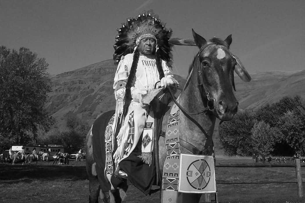 Horace Axtell rides a horse in Nez Perce regalia, June 2003. (Photo credit: Brenda Axtell)
