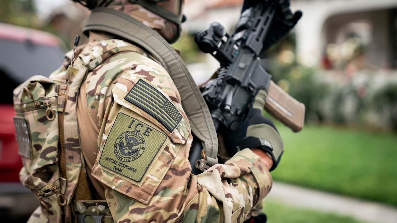 A U.S.  Immigration and Customs Enforcement (ICE) officer stands outside a Los Angeles residence as part of the agency’s enforcement and removal operations on June 12, 2025. (Department of Homeland Security/Tia Dufour) 