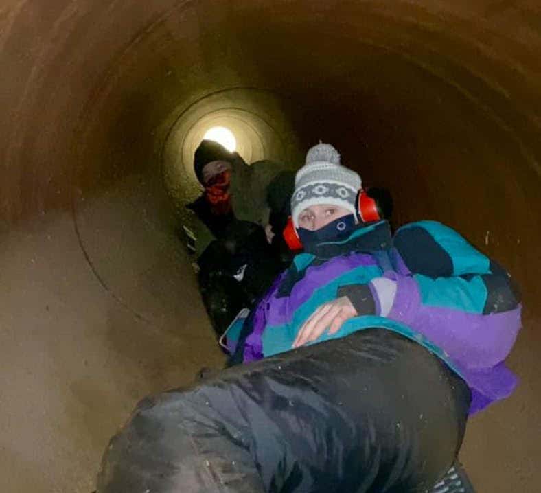 Water protectors chained themselves together inside a segment of Enbridge's Line 3, temporarily halting construction. (Photo courtesy of Ginew Collective)