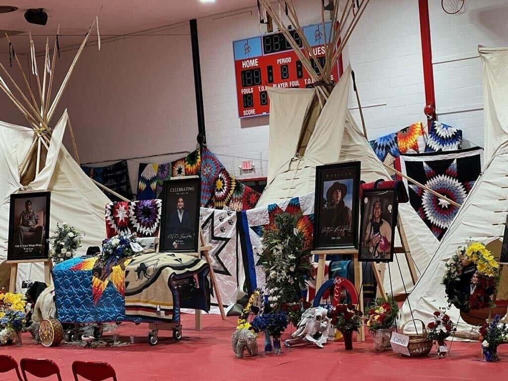 On Tuesday, April 16, the casket of Cole Brings Plenty rests before three tipis representing his family tiospayes. All photos reprinted with permission of Brings Plenty family. Photo Credit/Jodi Rave Spotted Bear
