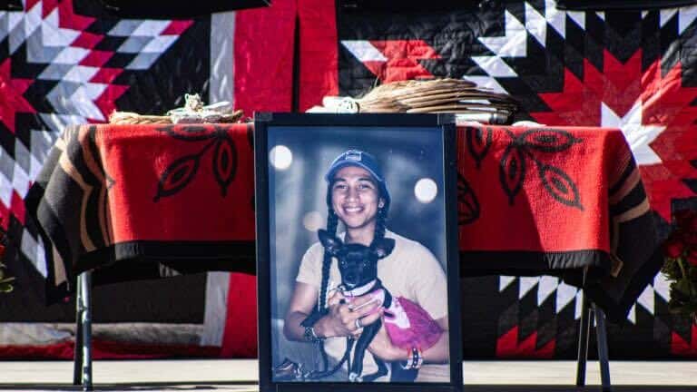 A photo of Cole Brings Plenty with his cousin Candi Brings Plenty's dog stood in the center of the Memorial Park Bandshell in Rapid City at an April 14 vigil. (Photo by Amelia Schafer, ICT/Rapid City Journal)