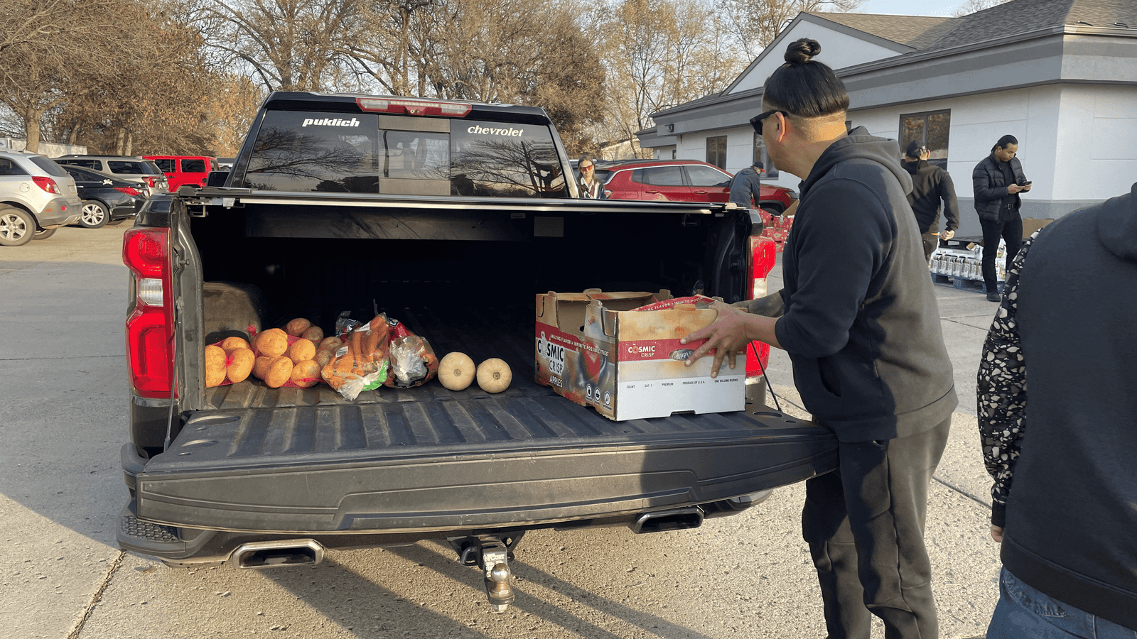 Volunteer Kory Annis, Lakota and enrolled citizen of the Cheyenne River Sioux Tribe, loads up a truck with food at Sacred Pipe Resource Center in Bismarck, North Dakota, Wednesday, Nov. 12, 2025.