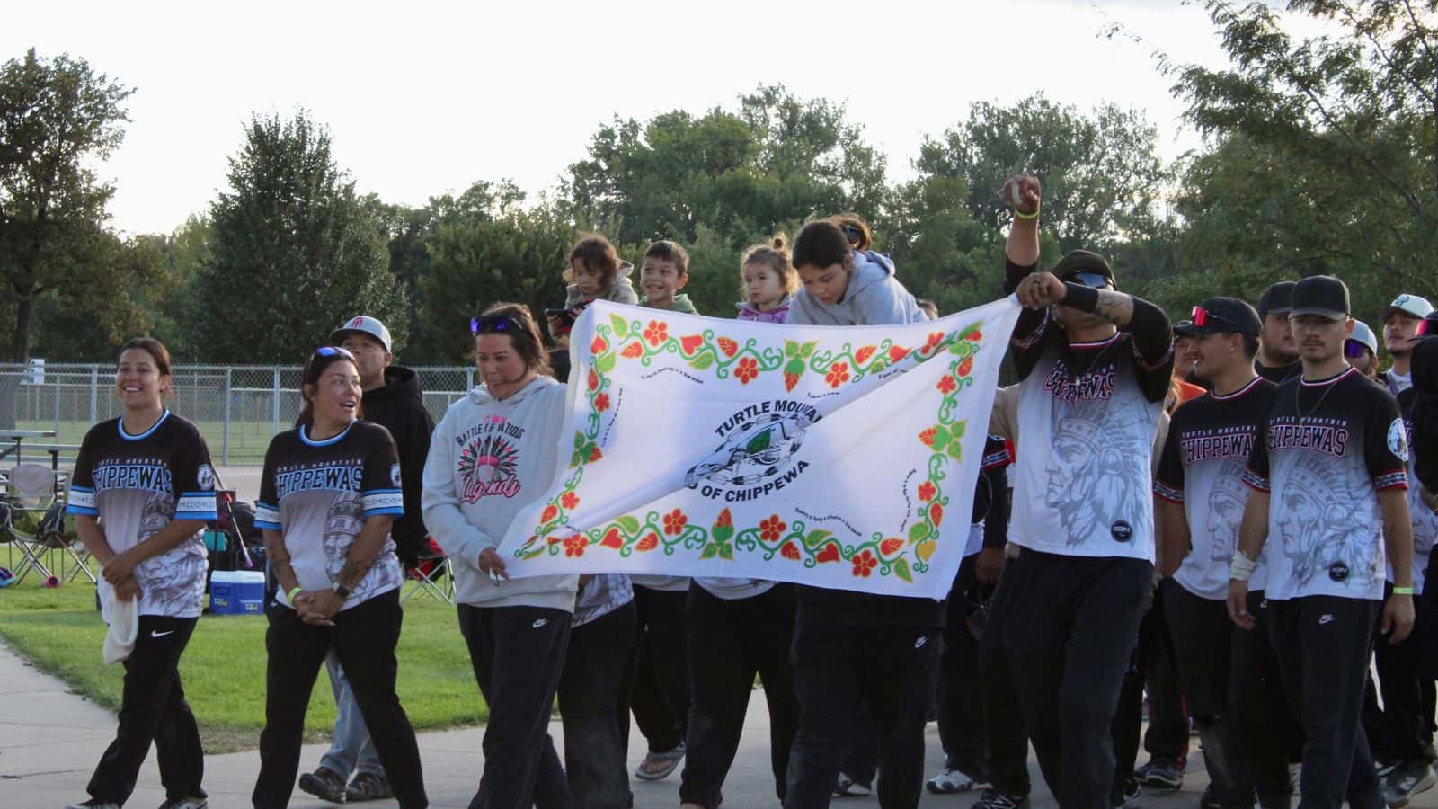 Turtle Mountain softball players march onto the field for the United Tribes Legends Softball Tournament grand entry, Bismarck, North Dakota, Sept. 5, 2025. (Buffalo's Fire Photo/Gabrielle Nelson)
