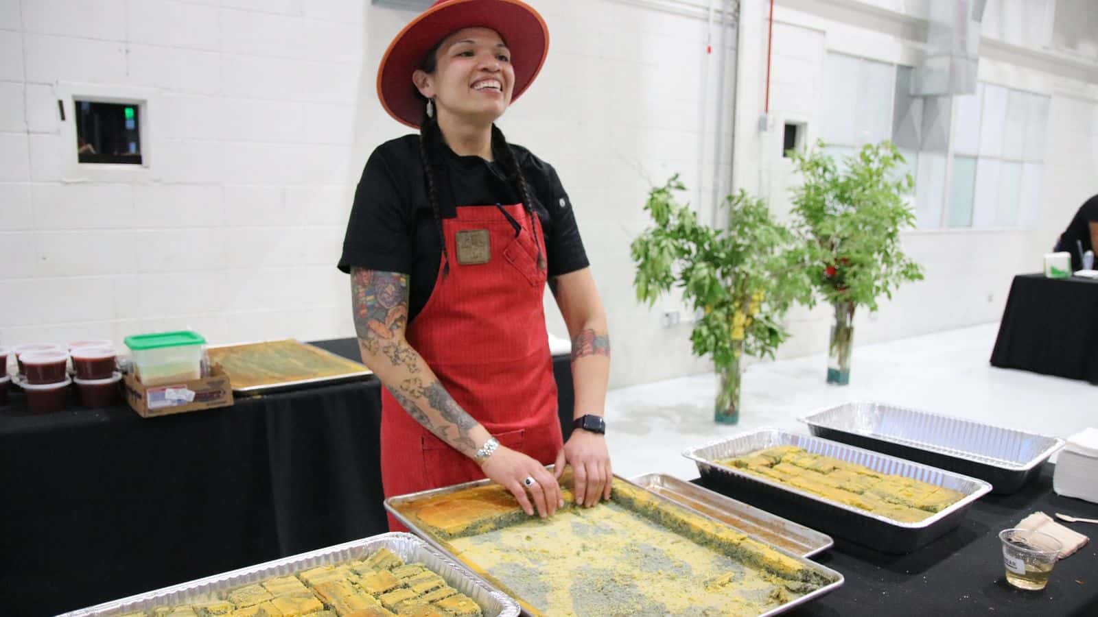 Emma VandenEinde
/
KUNC
Andean Chef Andrea Murdoch stands in front of her Ute Mountain Ute Blue Cornmeal Swirl cake at the Denver EATSS event at Stanley Marketplace in Aurora, Colo., on June 14, 2023. She's one of the five Indigenous chefs that were picked to share a meal with guests.