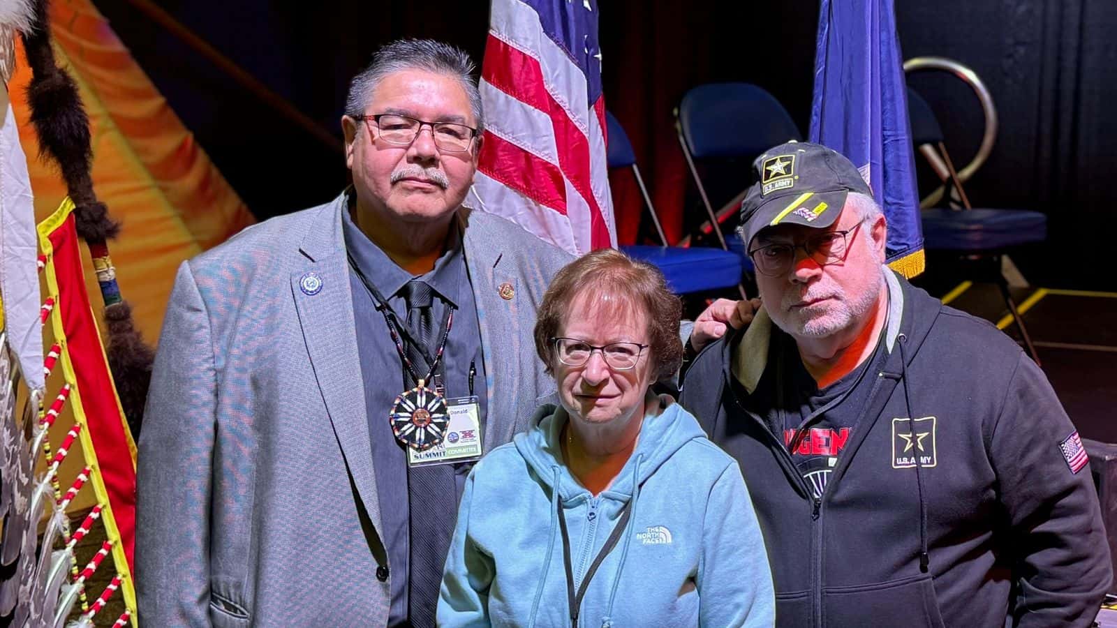 UTTC President Leander McDonald stands with Terry and Patty Leier at the UTTC Tribal Leaders Summit, Sept. 4, 2025. McDonald invited them onstage to thank them for a $100,000 donation that is seeding an endowment for UTTC students. (Buffalo’s Fire Photo/Erin Hoover Barnett)