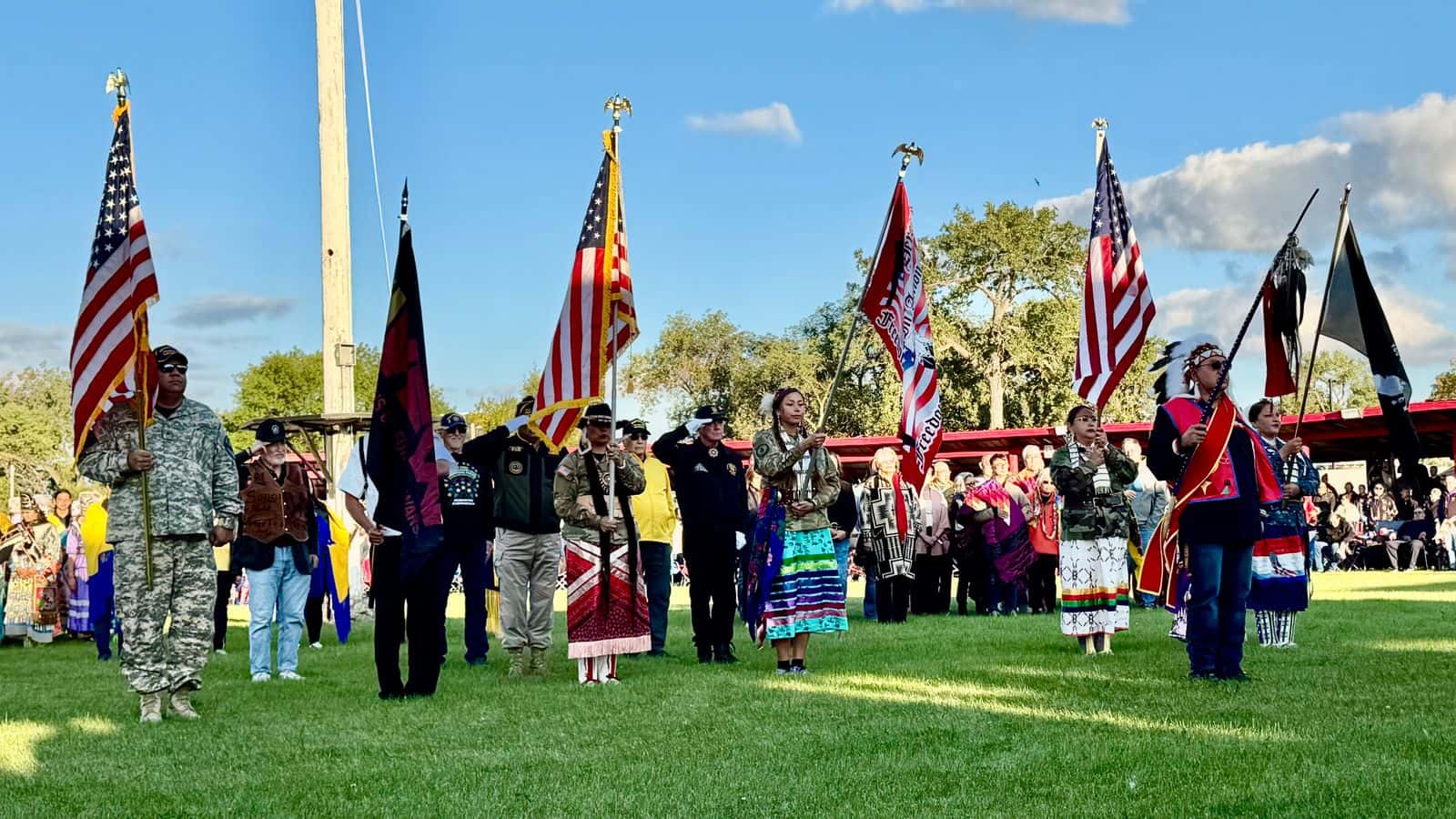 Frank Star Comes Out, president of the Oglala Sioux Tribe, and dignitaries stand at attention after leading the sacred procession into the arena during the first grand entry at the United Tribes Technical College International Powwow, in Bismarck, North Dakota, Sept. 5, 2025. (Buffalo’s Fire/Erin Hoover Barnett)