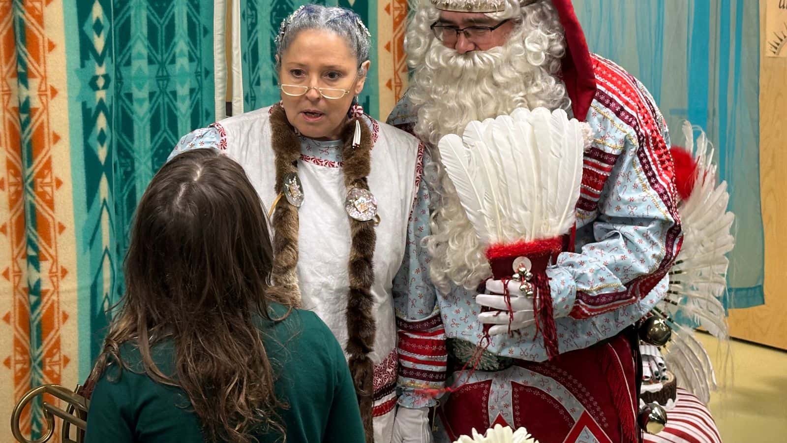 Mrs. Claus and Solte Santa discuss the holidays with a girl at the Chifin Native Youth Center in Springfield, Oregon, Sunday, December 14, 2025. (Buffalo’s Fire/Brian Bull)