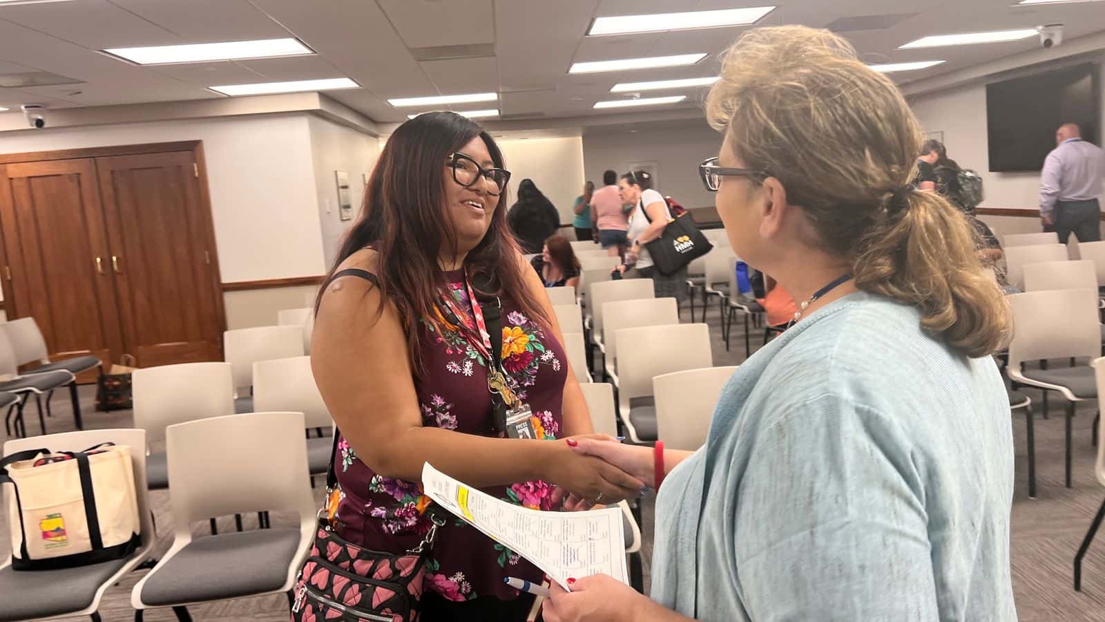 Adrianna Adame, Report for America corps member visits wtih Lucy Fredericks, director of Indian/multicultural education, during the North Dakota Indian Education Summit at the North Dakota State Capitol on Friday, July 7. (Photo/Jodi Rave Spotted Bear)