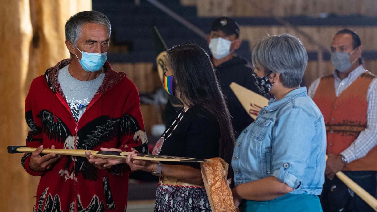 Steve Solomon of the Lummi Nation presents Shelly Boyd, middle, and the Confederated Tribes of the Colville Reservation with a gift of alliance between their Tribal Nations. Joined by her daughter Stevey Seymour, right, the members of the Sinixt/Arrow Lake band of the Confederated Tribes of the Colville Reservation spoke at the Indigenous Peoples Day celebration hosted by the Children of the Setting Sun Productions at the Wex'liem Community Building in Lummi Nation Monday, Oct. 1. The event, streamed via Zoom and Facebook, highlighted the contributions and diverse cultures of Indigenous peoples as well as the need for climate action.