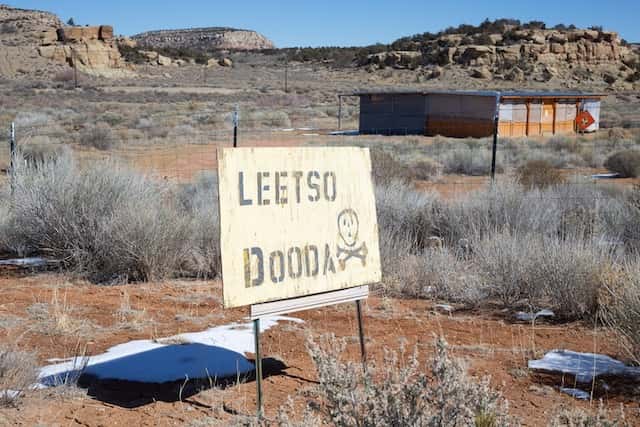 A sign in Diné reads “Leetso Dooda,” meaning “No Uranium,” stands south of the the Quivira (formerly Kerr-McGee) uranium mine in the Red Water Pond Road community and next to their meeting house where the community will hold the 43rd annual commemoration for the mine spill into the Rio Puerco.