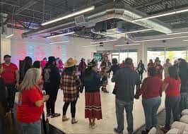 The Law Vegas Indian Center hosted a rally on Feb. 25 with speakers, entertainment, and an Indian taco sale fundraiser, with proceeds going toward survivors of sexual assault.  Here, some of the 70-something participants hold hands for a healing round dance. (Photo by Davis Thunderhawk, courtesy of Las Vegas Indian Center)