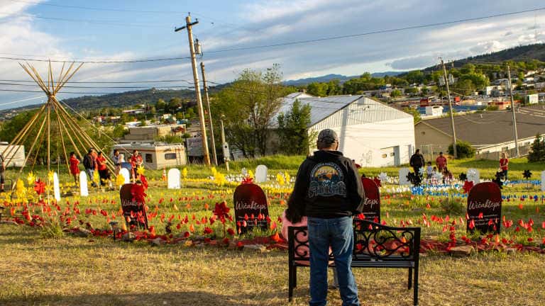 A couple stands overlooking NDN Collective's Wičaktepi Remembrance Garden in Rapid City. The garden was created to remember community members who died in fatal police-involved shootings in the city. (Photo by Amelia Schafer, ICT/Rapid City Journal)