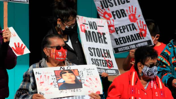 FILE - Family members of missing and slain Native Americans gathered to watch New Mexico Gov. Michelle Lujan Grisham sign legislation during a ceremony in Albuquerque, N.M., on Thursday, Feb. 24, 2022. New Mexico's governor isn't backing down on her decision to nominate a former tribal leader who once faced sexual assault charges to head the state's Indian Affairs Department. Advocates who have worked to address violence against Native American women and bring more attention to missing persons cases within their communities are pushing the state Senate to hold a confirmation hearing for James Mountain.