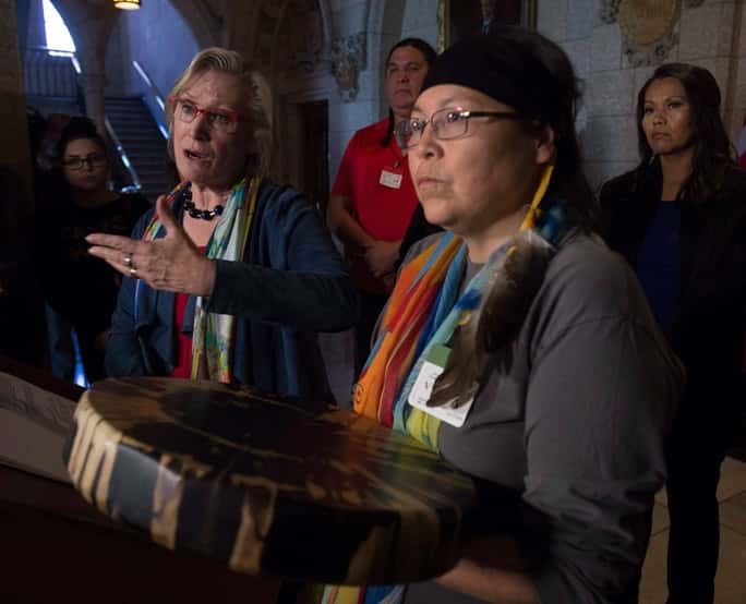 Chief Marcia Brown Martel (right) Sixties Scoop survivors and Crown-Indigenous Relations and Northern Affairs Minister Carolyn Bennett (left) - Adrian Wyld / The Canadian Press via AP