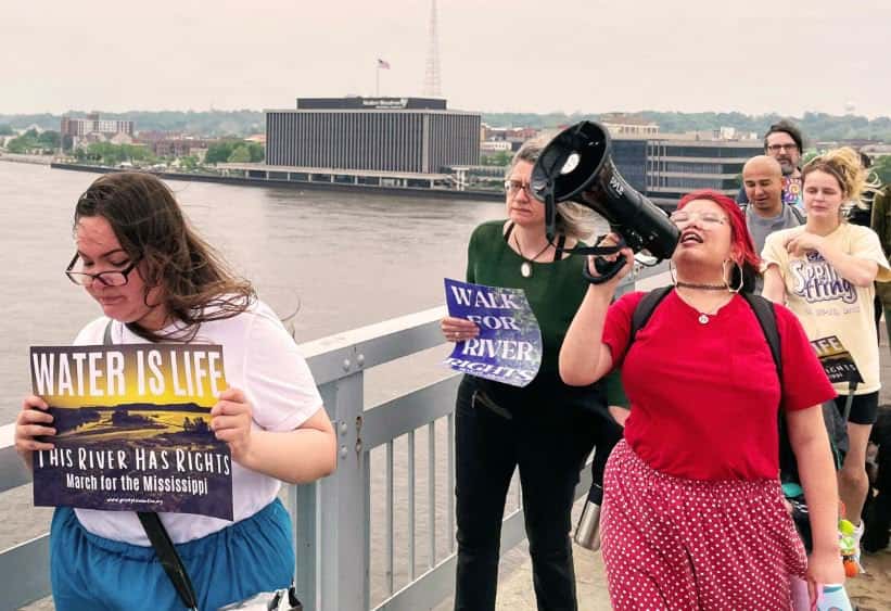 Advocates march over the Centennial Bridge, which connects Illinois and Iowa in the Quad Cities, on May 13, 2023. They called for the Mississippi River to be granted legal rights. (Juanpablo Ramirez-Franco, WNIJ)