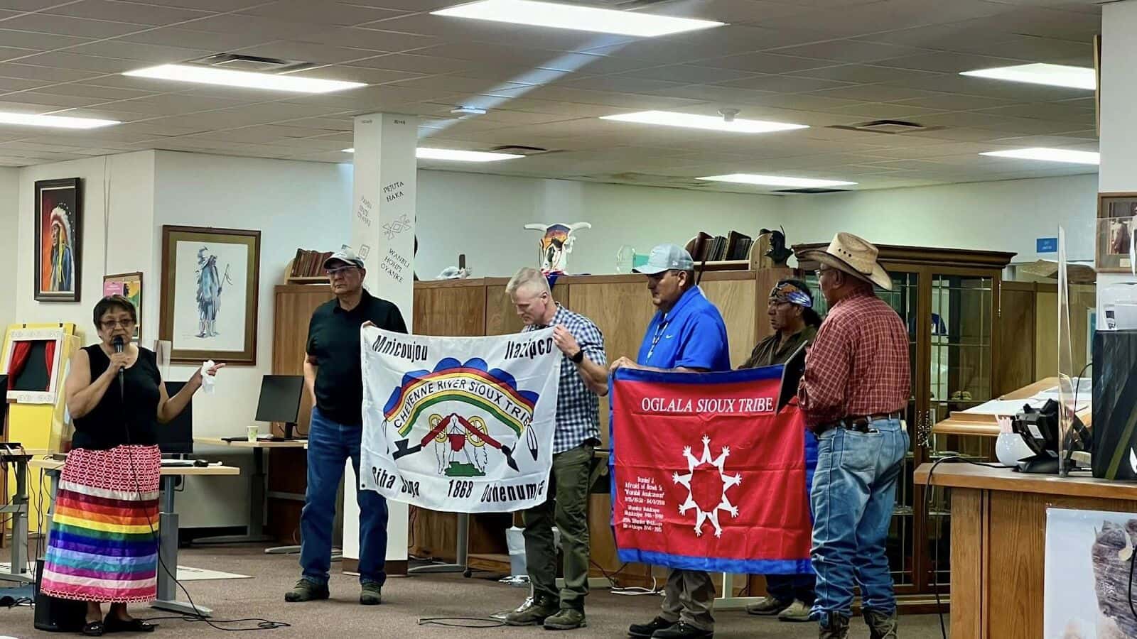 Wounded Knee descendants Prayer ceremony and oral history accounts at Oglala Lakota College Library. From left, Marlis Afraid of Hawk, John Afraid of Hawk, Panel Chair Tom James, and Justin Pourier. (Photo Credit/ Facebook/Frank Star Comes Out)