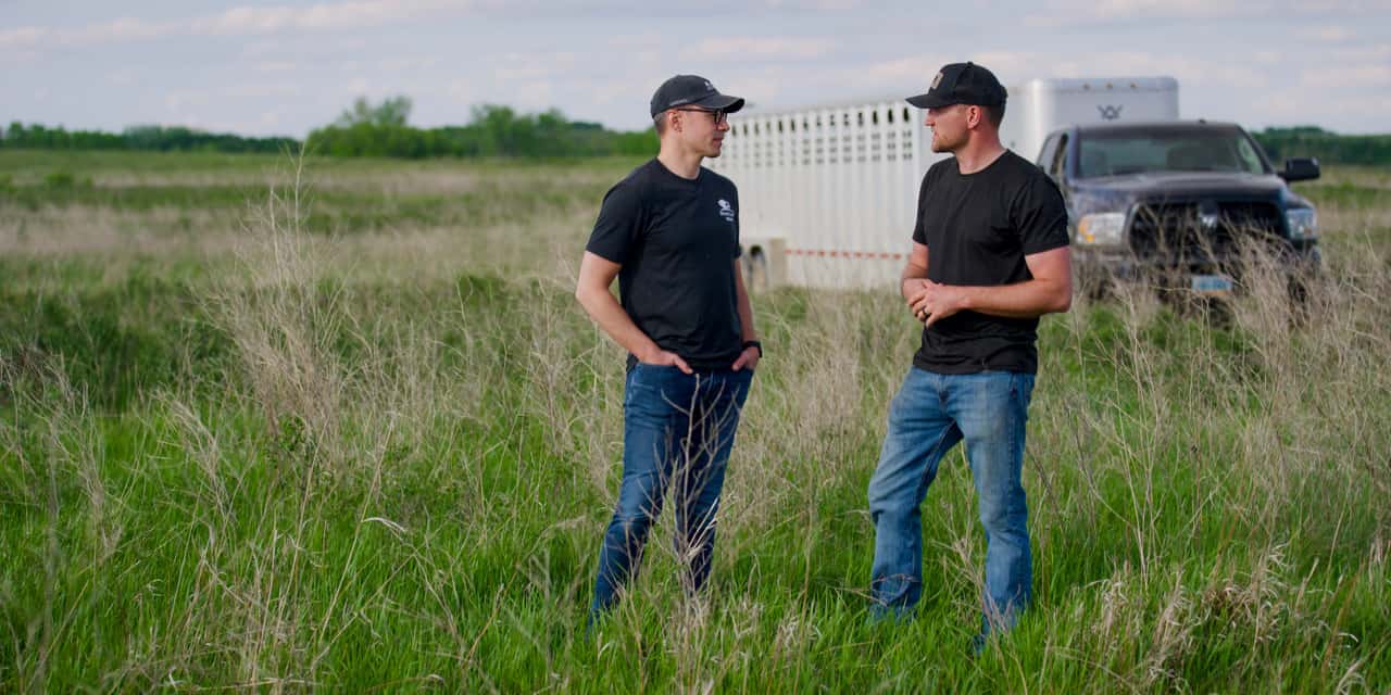 Cory Hepola [right] speaks with Kevin Leier of Heartland Bison Ranch. Photo by The Brookshire Company. 