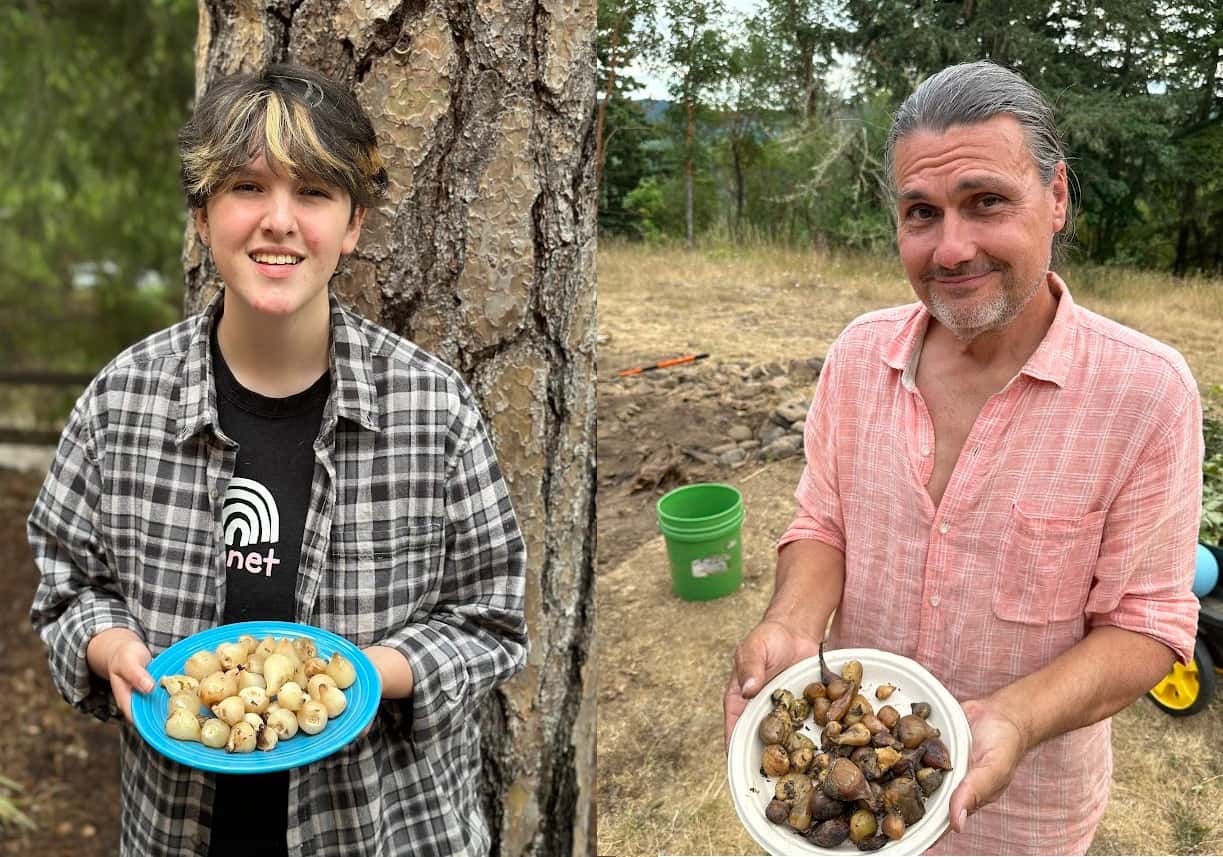 TEIP senior intern Sam Bull (left) and TEIP leader Joe Scott (right) hold plates of their respective camas bulbs after a weekend camas bake, July 20. (Photo credit: Brian Bull)
