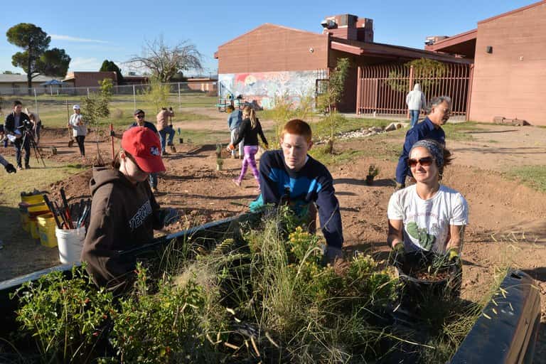 Students, nonprofit and grassroots organizations construct green infrastructure that will direct stormwater to native trees and grasses they are planting to improve the landscape at Star Academic High School.
Norma Jean Gargasz for High Country News