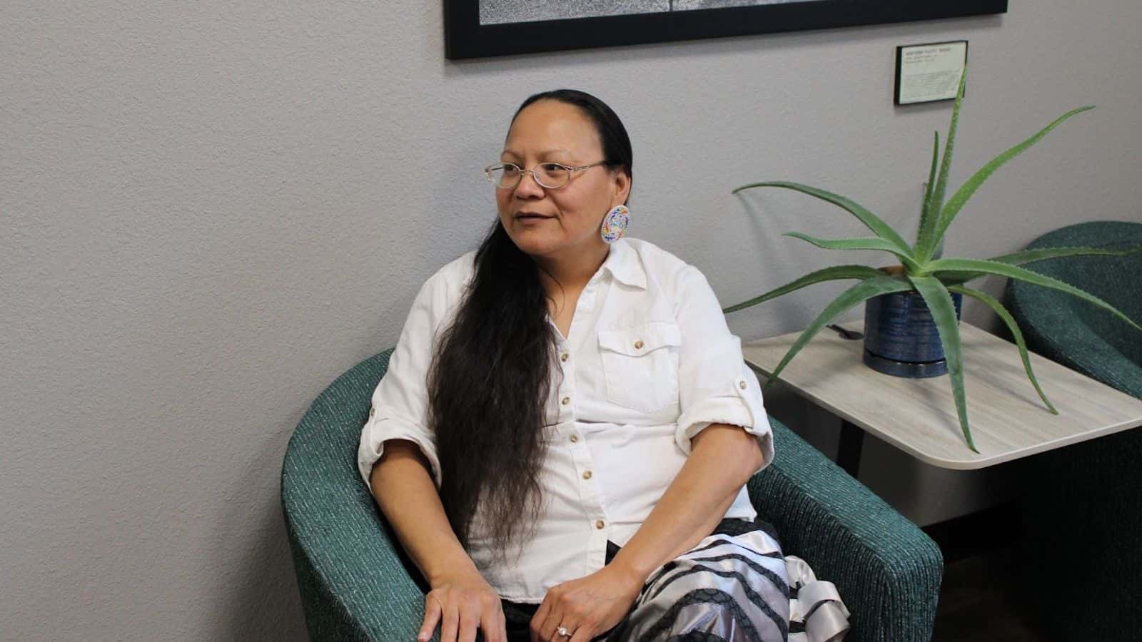 Elizabeth BlackDogBear said she helped found 2 Spirit Club at United Tribes Technical College because she knows how difficult it is for those identifying as LGBTQ+ to find acceptance and community. Here she is pictured in the lobby outside the club’s meeting room on Oct. 18. (Photo credit/ Adrianna Adame)
