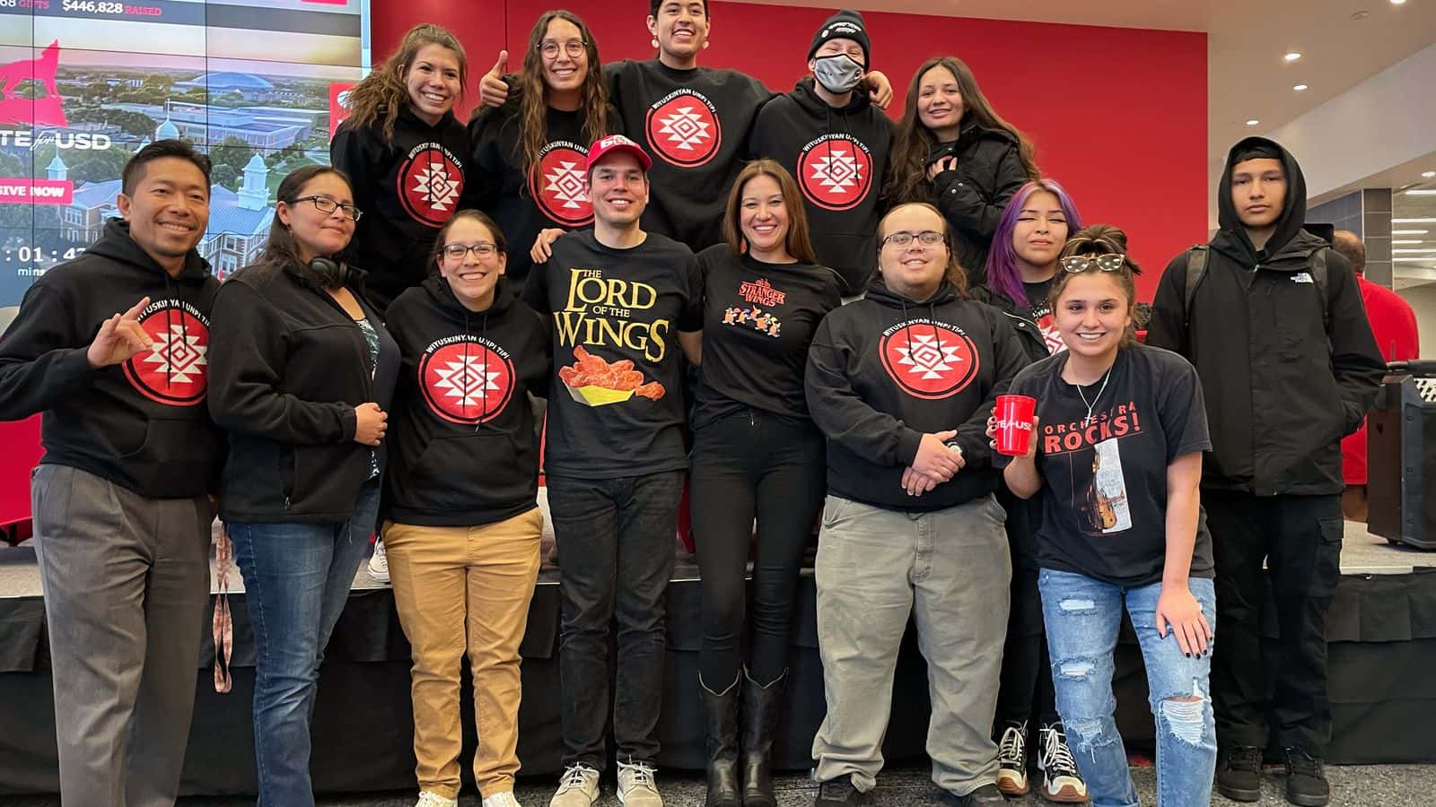 John Little and Megan Red Shirt-Shaw join Wiyuskinyan Unpi Tipi Living Learning Community students and staff at the Unite for USD fundraiser, March 1, 2023. The couple, in the center, entered a hot wing-eating challenge to raise money for the LLC programming.