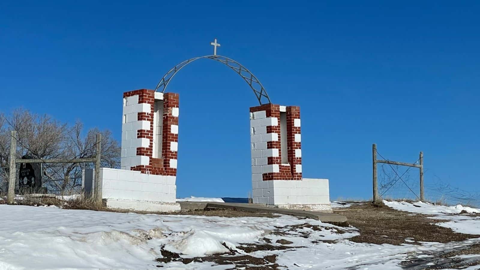 The Wounded Knee Memorial, shown here in February 2023, marks the site of the massacre of hundreds of Lakota people by U.S. soldiers in 1890. A ceremony marking the 50 years since the occupation of Wounded Knee by American Indian Movement activists will be held at the site on Feb. 27, 2023, after four days of events leading up to the anniversary. (Photo by Kalle Benallie/ICT)
