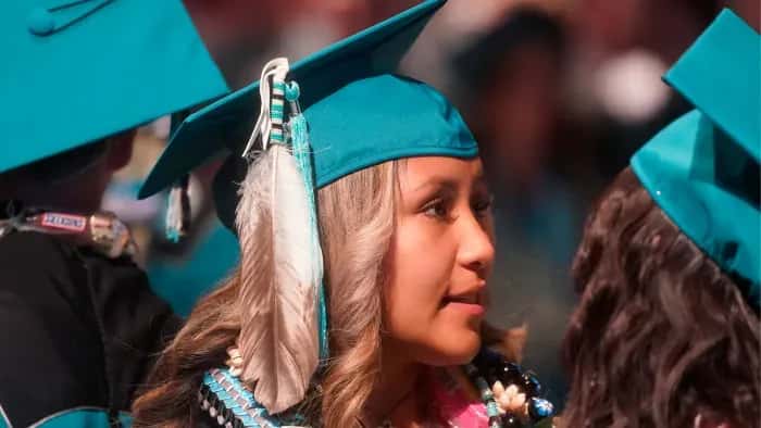 In this file photo, Brailyn Jake wears an eagle feather at her graduation from Cedar City High School in Cedar City, Utah, on May 25, 2022. Utah is among 11 states with laws that specifically protect the right of Indigenous students to wear regalia at graduation ceremonies. On May 1, 2023, Oklahoma Gov. Kevin Stitt vetoed a a bipartisan bill that would have allowed Native students across the state to wear regalia during graduation ceremonies. Tribal leaders are now calling for the Oklahoma legislature to override the veto. (AP Photo/Rick Bowmer)