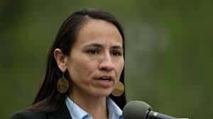 In this 2019 photo, Rep. Sharice Davids addresses people attending a sign unveiling ceremony for the Quindaro Townsite National Commemorative Site in Kansas City, Kansas. (AP Photo/Charlie Riedel, File)