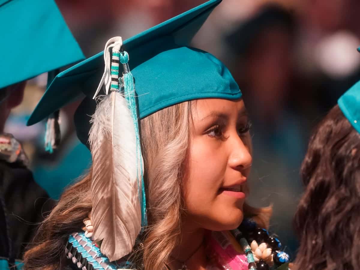 In this file photo, Brailyn Jake wears an eagle feather at her graduation from Cedar City High School in Cedar City, Utah, on May 25, 2022. Utah is among 11 states with laws that specifically protect the right of Indigenous students to wear regalia at graduation ceremonies. On May 1, 2023, Oklahoma Gov. Kevin Stitt vetoed a a bipartisan bill that would have allowed Native students across the state to wear regalia during graduation ceremonies. Tribal leaders are now calling for the Oklahoma legislature to override the veto. (AP Photo/Rick Bowmer)