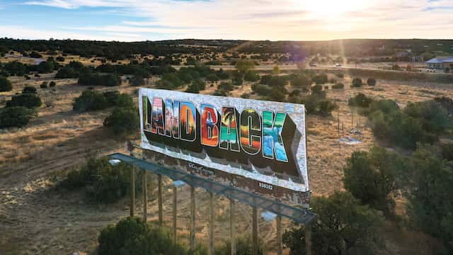 A billboard designed by artist Votan Henriquez was installed in Edgewood, New Mexico, as part of@landback.art.

Roberto E. Rosales/@landback.art
 