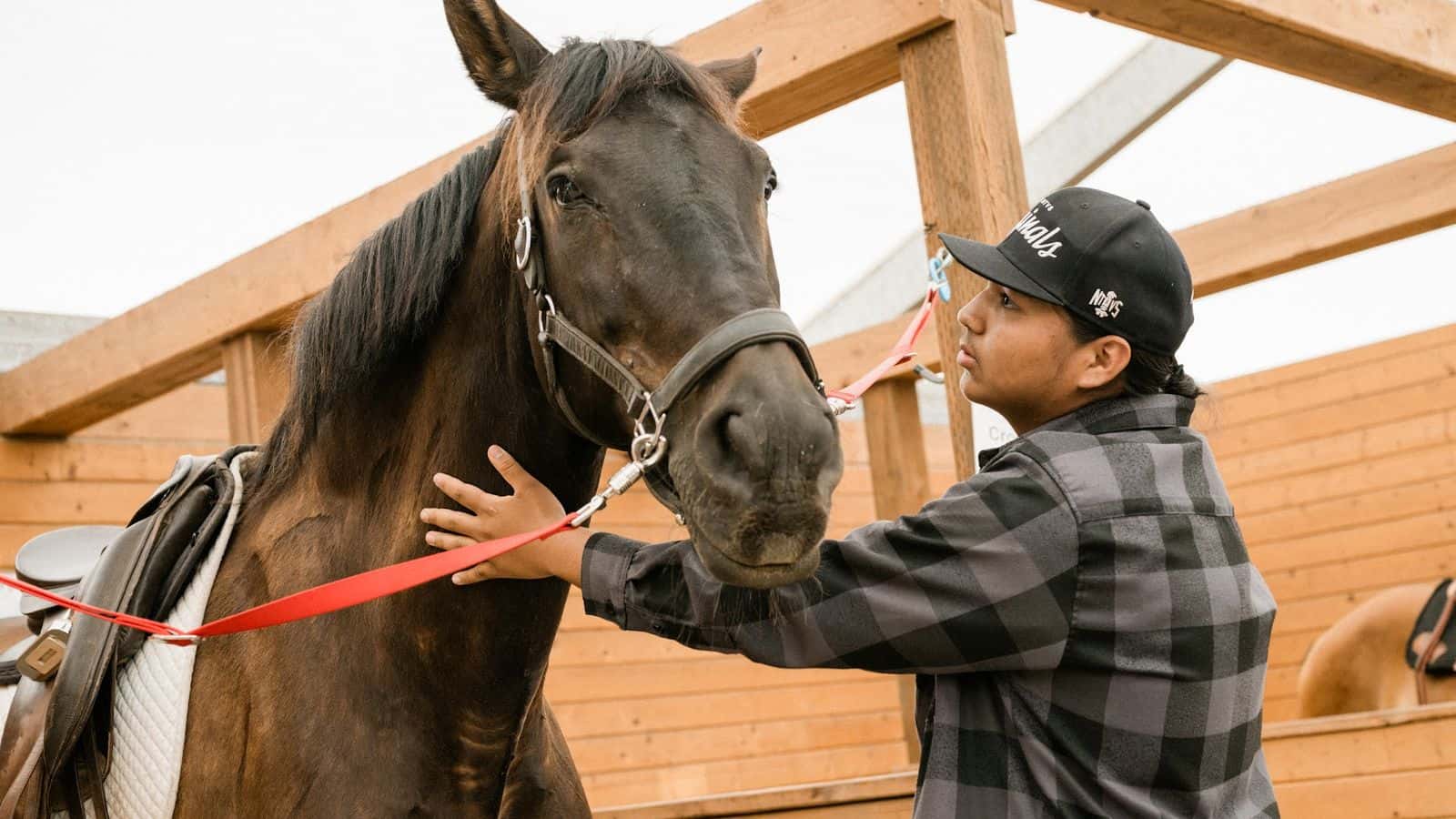 Rocky makes a special connection with Oso at Forward Stride ranch near Beaverton, Oregon. The ranch provides Indigenous youth with equine therapy. Photo by Josué Rivas.