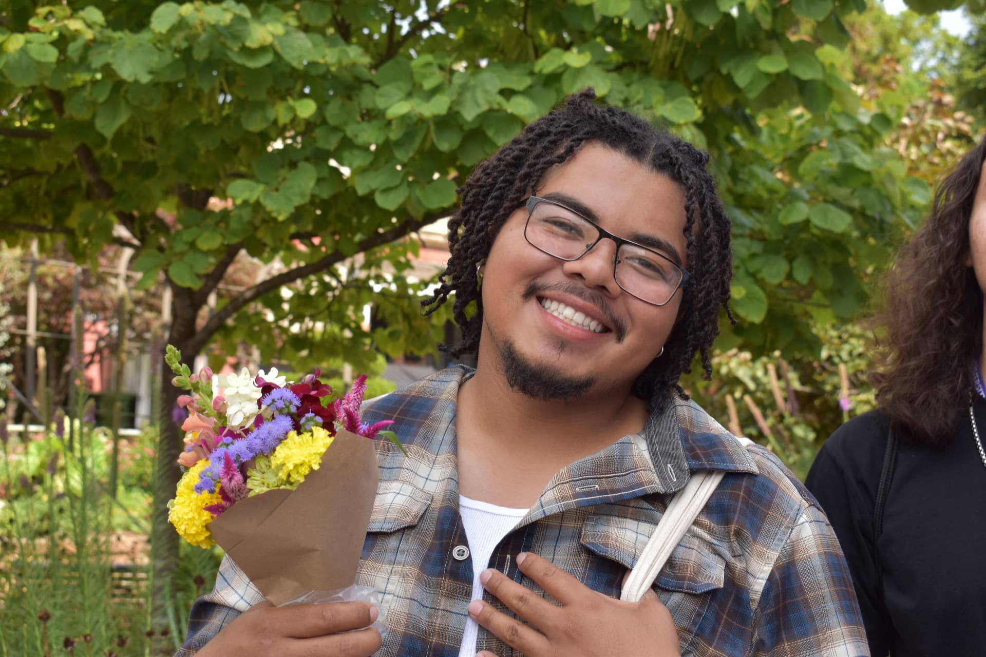Summit attendee, Chris Aguilar (San Felipe Pueblo), enjoys the Fayetteville Farmer's Market as part of the 2024 Native Youth in Food and Agriculture Leadership Summit.  Photo by Arvcuken Noquisi