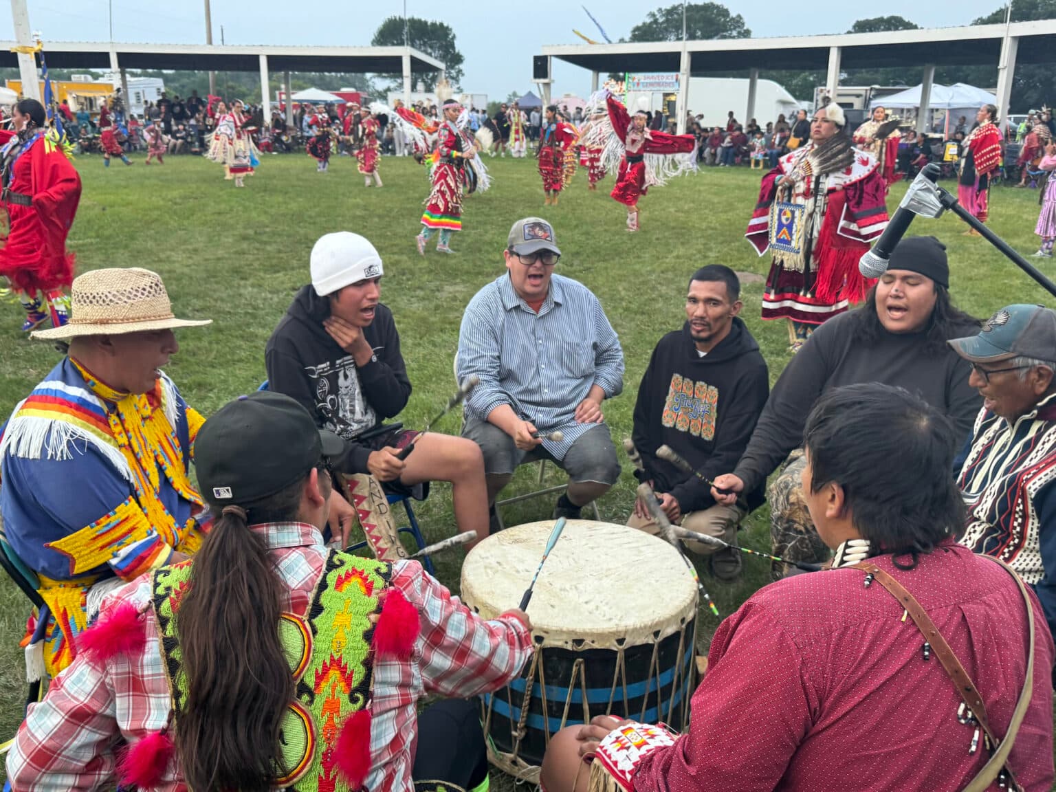 Drummers bring their dedication, passion, and talent to the Red Dress Special. “For us to be chosen to sing for something so meaningful, it just meant so much more,” said Cameron Red Bear, pictured wearing the plaid shirt. “I felt proud to sing for it.” (Photo credit: Erin Hoover Barnett) 